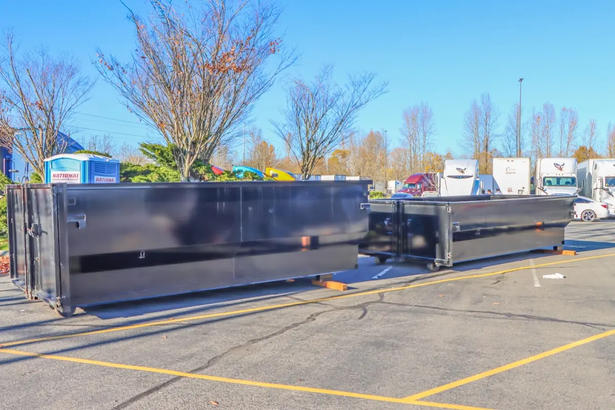 Professional dumpster rental service with roll-off container on residential driveway in New Hanover